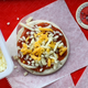 Homemade Pizza Lunchable with shredded cheese on top
